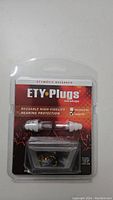 Close-up of packaged ETY Plugs reusable high-fidelity hearing protection earplugs with carrying case inside.