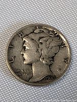 Obverse side of 1945 USA Silver Mercury Dime showing Liberty's winged head and date.