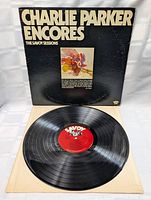 Vinyl record out of sleeve showing red Savoy label on the center with the grooves.