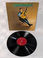 Photo of vinyl LP record and album cover of Gordon Lightfoot's debut album, Lightfoot!. Cover shows artist seated with guitar.