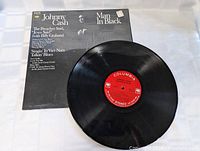 Vinyl LP record removed from its cover, showing red Columbia label and black vinyl in excellent condition with light surface wear.