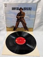 The vinyl record removed from cover, showing red Columbia label and surface condition.