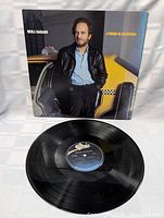 Front cover photo of Merle Haggard's A Friend In California album with artist leaning on taxi car door