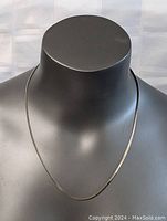 Front view of sterling silver chain necklace displayed on black mannequin bust showing the necklace hanging around the neck area.