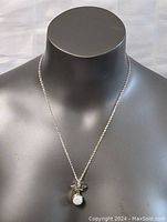 Full view of necklace displayed on mannequin showing chain length and pendant position