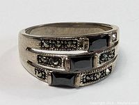 Front view of vintage sterling silver ring with rectangular black onyx stones and dark rhinestones.