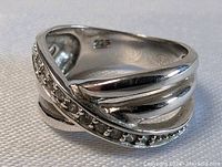 Top and side views of the sterling silver ring, showing the multi-band design and bead detailing with the 925 and AJE hallmarks inside.