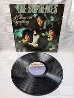 Vinyl LP record laid on a white surface showing the black Motown label and grooved vinyl surface, indicating playable condition