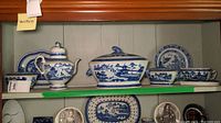 Shelf display showing teapot, covered tureen, gravy boat, oval platter and round plate