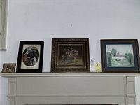 Photo showing all four items on a mantelpiece: two original paintings, the vintage etching print, and the wax cast.