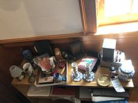 Wide shot of table with assortment of vintage items including Mason's Blue Willow ceramics, figurines, candlesticks and small collectibles