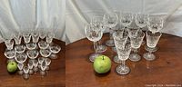 All 39 glasses arranged on table with green apple for scale.