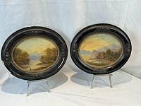 Front view of both oval framed paintings