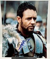 Close-up showing detailed view of Russell Crowe in Gladiator costume with the blue ink signature on the photo.