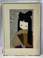 Full view of the framed woodblock print showing a stylized girl with a fan and wood grain background.
