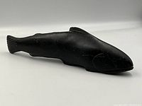 Side profile of black soapstone salmon sculpture