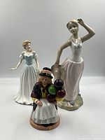 Photo showing all three porcelain figurines together with a white background.