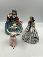 All three figurines displayed front-on against white background