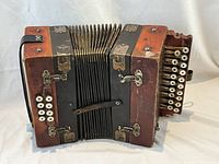 Front view showing wooden body, bellows and hardware