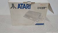 Front of original Atari 1040STFM cardboard box with logo and illustration