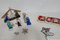 Full view of stained glass Nativity scene pieces, picture frame set, and Angel nightlight on white background.