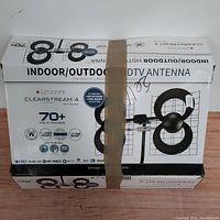 Box front with product image and key features, shows 70+ mile range and 4K UHD ready.