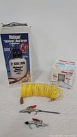 Full lot showing Wolman deck sprayer box, yellow coiled air hose, two metal air nozzles, and Shop-Vac air filter box