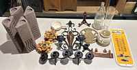 Photo showing the full assortment of candle holders, thermometer, glassware, and decorative pieces arranged on a shelf.
