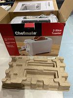 Chefmate 2-Slice toaster in original box with packaging tray visible