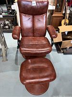 Front view of brown faux leather massage chair and footrest