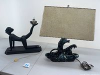 Both lamps side by side showing the gymnast lamp and ceramic panther lamp with the shade on a white surface.