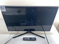 Samsung 32 inch TV on stand with remote control in front, screen showing No Cable Connected message