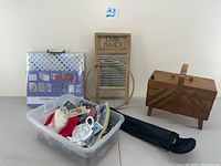Entire lot including wooden sewing box, scrapbook kit, sewing supplies bin, washboard, and umbrella.