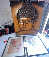 Large wood carved Buddha face wall hanging shown upright with three vertical panels, natural wood grain with darker stained edges.