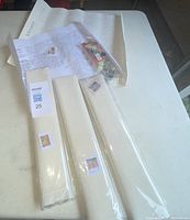 Four new paint by number kits including canvases, paints, brushes, and color guides laid out on a table.