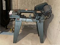Front view of the full metal cutting band saw on its stand.