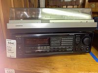 Front and top view of Onkyo turntable CP-101A on top of Onkyo receiver TX-906 showing model info and controls