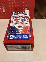 Box showing 9 decks of Bicycle Standard playing cards with two blue back decks and one visible red back deck, brand new sealed packaging