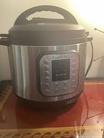 Front view of Instant Pot Duo Plus electric pressure cooker with digital buttons and display.