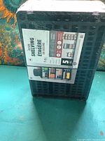 Front view of the new shrink-wrapped shelving unit with label showing product name and dimensions.