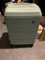 Front view of light green suitcase with ridged design and Heys logo.