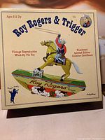 Box front showing Roy Rogers and Trigger wind-up tin toy, with text indicating vintage reproduction and numbered limited edition certificate.