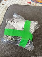 Ten Dodge Ram centre caps sealed in clear plastic bags held together with green tape.