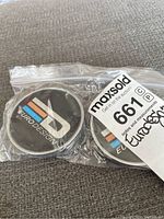 Two Eurodesign centre caps in a clear zip bag with a MaxSold lot sticker