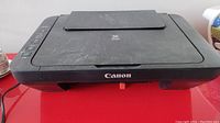 Front view of Canon Pixma MG2525 printer showing overall condition with dust and Canon logo on front.