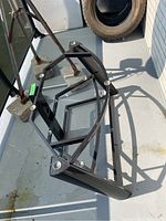 Top view of the metal base showing the frame structure and mounting points for the glass shelves.