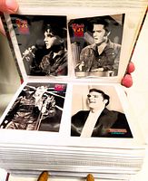 Open album showing four Elvis Presley trading cards from the Elvis 68 Comeback Special.
