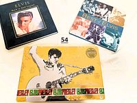 Top view showing two Elvis Presley hardcover books and one rectangular candy tin with Elvis image