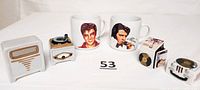 Front view of two Elvis Presley vintage salt and pepper shaker sets and two coffee/tea mugs with Elvis images and signatures.