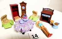Complete view of all 11 pieces in the set including furniture and accessories arranged with female doll figure and orange cat.